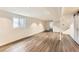 Large basement featuring wood floors, white walls, and a small window letting in natural light at 16780 E Hialeah Ave, Centennial, CO 80015