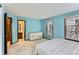 Comfortable bedroom with a view to an en-suite bathroom, a dresser, and carpeted floors at 16780 E Hialeah Ave, Centennial, CO 80015