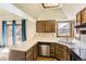 Kitchen featuring ample countertop space, wood cabinets, and stainless steel appliances, plus a view to the backyard at 16780 E Hialeah Ave, Centennial, CO 80015