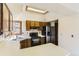 A well-lit kitchen with a skylight, oak cabinets, laminate countertops, and stainless-steel appliances at 16780 E Hialeah Ave, Centennial, CO 80015