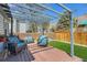 Backyard patio with wicker seating and a view of the landscaped yard and wooden fence at 4071 E 126Th Pl, Thornton, CO 80241