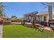 Landscaped backyard with artificial grass, brick patios, and a storage shed at 4071 E 126Th Pl, Thornton, CO 80241