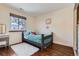Cozy bedroom featuring a wood frame bed, plush rug, and natural light from the window at 4071 E 126Th Pl, Thornton, CO 80241