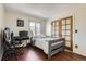 Bedroom featuring hardwood floors and a door to the outside at 4071 E 126Th Pl, Thornton, CO 80241