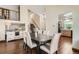 Bright dining area with hardwood floors, stylish lighting, and views into the living room and stairs at 4071 E 126Th Pl, Thornton, CO 80241