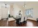 Elegant dining area with hardwood floors, modern lighting, and views of the front entrance at 4071 E 126Th Pl, Thornton, CO 80241