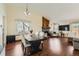 Open-concept dining area with hardwood floors, stylish lighting, and seamless flow to the living room at 4071 E 126Th Pl, Thornton, CO 80241