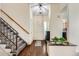 Bright foyer with wood floors, staircase, and views into the dining and living spaces at 4071 E 126Th Pl, Thornton, CO 80241
