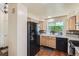 Bright kitchen features wood floors, stainless steel appliances, and a window overlooking the backyard at 4071 E 126Th Pl, Thornton, CO 80241