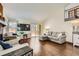 Spacious living room with hardwood floors, ample natural light, and comfortable seating at 4071 E 126Th Pl, Thornton, CO 80241