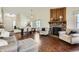 Inviting living area with a fireplace, dining space, and hardwood flooring throughout at 4071 E 126Th Pl, Thornton, CO 80241