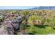 Gorgeous aerial view of neighborhood homes near a tennis court with views of the mountains and a tree-lined community at 4059 Nevis St, Boulder, CO 80301