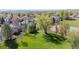 Aerial view showing the property's location near a park with tennis court, with mature trees in the neighborhood at 4059 Nevis St, Boulder, CO 80301