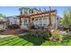 Backyard deck with a pergola, outdoor seating, and a well-manicured lawn at 4059 Nevis St, Boulder, CO 80301