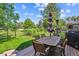Outdoor deck with a dining table and chairs under an umbrella, perfect for entertaining and enjoying the backyard view at 4059 Nevis St, Boulder, CO 80301