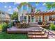 Inviting backyard deck with wood pergola, table, grill, and seating area surrounded by well-maintained landscaping at 4059 Nevis St, Boulder, CO 80301