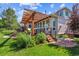 Backyard deck with pergola and outdoor seating area overlooking a lush garden and well-maintained lawn at 4059 Nevis St, Boulder, CO 80301