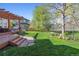 Beautiful backyard with a well-maintained lawn, mature trees, and a fence, perfect for outdoor activities and relaxation at 4059 Nevis St, Boulder, CO 80301
