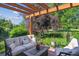 Cozy backyard seating area with comfortable outdoor furniture, pergola, and lush landscaping for relaxation at 4059 Nevis St, Boulder, CO 80301
