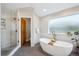 Elegant bathroom featuring a soaking tub, glass-enclosed shower, and a serene, spa-like atmosphere at 4059 Nevis St, Boulder, CO 80301