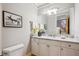 Stylish powder room with marble countertops, white cabinetry, and contemporary fixtures at 4059 Nevis St, Boulder, CO 80301