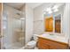 Updated bathroom featuring glass enclosed shower, wood vanity, and neutral tile at 4059 Nevis St, Boulder, CO 80301