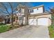 Charming two-story home featuring a well-manicured front yard, brick accents, and a spacious two-car garage at 4059 Nevis St, Boulder, CO 80301