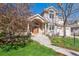 Beautiful home with a brick-accented entry, arched doorway, and mature landscaping at 4059 Nevis St, Boulder, CO 80301