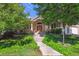 Inviting home exterior with manicured front yard and brick facade and pillars at 4059 Nevis St, Boulder, CO 80301
