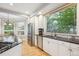 Bright kitchen features stainless steel appliances, stone counters, and ample natural light from large windows at 4059 Nevis St, Boulder, CO 80301