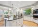 Bright kitchen featuring an island with seating, stainless appliances, and natural light at 4059 Nevis St, Boulder, CO 80301