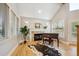 Bright living room with fireplace, piano, hardwood floors, and lots of natural light at 4059 Nevis St, Boulder, CO 80301