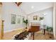 Living room featuring a fireplace, piano, hardwood floors, and an abundance of natural light at 4059 Nevis St, Boulder, CO 80301