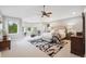 Spacious main bedroom with a seating area, neutral color scheme, and large windows providing natural light at 4059 Nevis St, Boulder, CO 80301