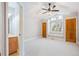 Bright main bedroom features large window, vaulted ceiling with fan, and ensuite bathroom at 4059 Nevis St, Boulder, CO 80301