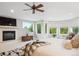 Sunlit main bedroom features a fireplace, sitting area, and large windows offering serene outdoor views at 4059 Nevis St, Boulder, CO 80301