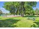 Scenic shot of community tennis courts under a large shade tree, offering a serene recreational setting at 4059 Nevis St, Boulder, CO 80301
