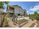 Landscaped backyard featuring a deck, gravel area, and raised garden beds at 7201 W Asbury Pl, Lakewood, CO 80227
