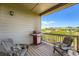 Balcony featuring a gas grill, two chairs, and a scenic neighborhood view at 7201 W Asbury Pl, Lakewood, CO 80227