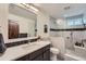 Bathroom featuring a glass enclosed shower, dark wood vanity, and modern fixtures at 7201 W Asbury Pl, Lakewood, CO 80227
