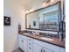 Bathroom featuring double vanity, large mirror, modern fixtures and neutral colors at 7201 W Asbury Pl, Lakewood, CO 80227