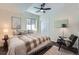 Comfortable bedroom with a ceiling fan, ample natural light, and a stylish chair at 7201 W Asbury Pl, Lakewood, CO 80227