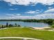 Beautiful community lake with sandy beach area and a grassy park area for recreational activities at 7201 W Asbury Pl, Lakewood, CO 80227
