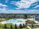 An aerial view of a community pool and clubhouse featuring a pool with lounge chairs, hot tub, and mountain views at 7201 W Asbury Pl, Lakewood, CO 80227