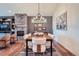 Elegant dining room featuring a stone fireplace, stylish decor, and a modern chandelier at 7201 W Asbury Pl, Lakewood, CO 80227