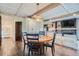 Dining room with wood floors and an overhead light fixture adjacent to living room at 7201 W Asbury Pl, Lakewood, CO 80227