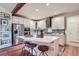 Well-lit kitchen with stainless steel appliances, a center island with seating, and ample storage space at 7201 W Asbury Pl, Lakewood, CO 80227