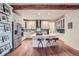 Modern kitchen featuring custom cabinets, stainless steel appliances, a center island and hardwood flooring at 7201 W Asbury Pl, Lakewood, CO 80227