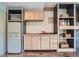 Kitchenette area with cabinets, shelving, a refrigerator and plenty of storage at 7201 W Asbury Pl, Lakewood, CO 80227