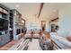 Bright living room with a stone fireplace, a cozy seating area, and seamless flow to the dining room at 7201 W Asbury Pl, Lakewood, CO 80227